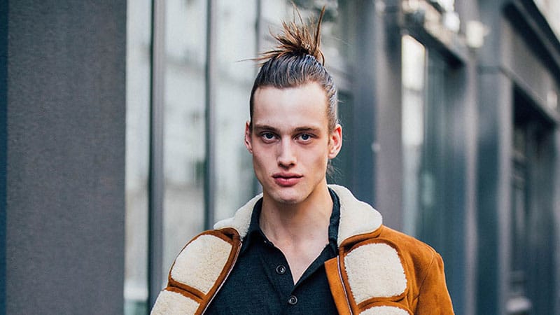 A man with a hairstyle Top Knot or A Man's Bun on a blue background, men's  hairstyles, hair care 18903177 Stock Photo at Vecteezy