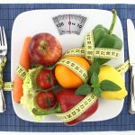 Fruits-and-vegetables-with-measuring-tape-on-a-plate-as-weight-scale